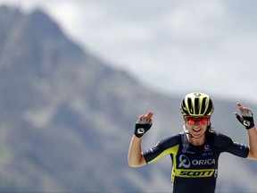 Annemiek van Vleuten, of the Netherlands celebrates as she crosses the finish line to win the first stage of La Course by Le Tour de France, a women's cycling race, over 67.5 kilometers (41,6 miles) with start in Briancon and finish on Izoard pass, France, Thursday, July 20, 2017. (AP Photo/Christophe Ena)