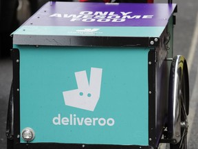 A deliveroo logo on a bicycle in London, Tuesday, July 11, 2017. A former adviser to Tony Blair is unveiling a much-anticipated report on the so-called gig economy, and has advised additional protection for workers in facing of vanishing job security. Unions and employment lawyers have criticized the report, saying it offered a feeble response to the growing number of workers in delivery and taxi firms such as Deliveroo and Uber. (AP Photo/Frank Augstein)
