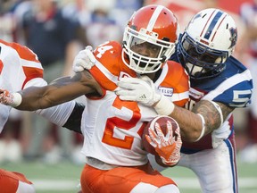 Alouettes defensive end Gabriel Knapton tackles B.C. Lions running back Jeremiah Johnson during first half CFL action in Montreal on Thursday night.