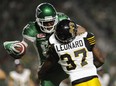 Saskatchewan Roughriders wide receiver Duron Carter (89) gets tangled up with Hamilton Tiger-Cats linebacker Will Smith (37) after making a grab during second half CFL football action in Regina on Saturday, July 8, 2017.