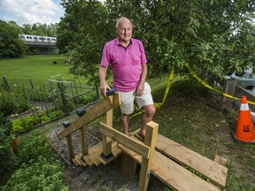 Adi Astl at the top of the staircase he built and the city has removed as of Friday morning in Tom Riley Park, near Islington Ave. and Bloor St. W. in Toronto, Ont.