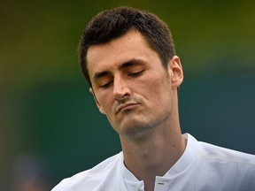 Bernard Tomic reacts during his first-round match against Mischa Zverev at Wimbledon on July 4.