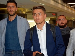 Roma new Turkish midfielder Cengiz Under, center, arrives at the Leonardo da Vinci international airport in Fiumicino, near Rome, Friday, July 14, 2017. (Telenews/ANSA via AP)