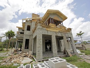 This Thursday, June 8, 2017, photo shows a new home under construction, in Miami Springs, Fla. On Tuesday, July 18, 2017, the National Association of Home Builders/Wells Fargo releases its July index of builder sentiment. (AP Photo/Alan Diaz)