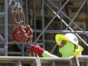 In this Thursday, June 15, 2017, photo, a construction worker continues work on a condominium project in Coral Gables, Fla. On Friday, July 7, 2017, the Labor Department will release the U.S. jobs report for June. (AP Photo/Alan Diaz)