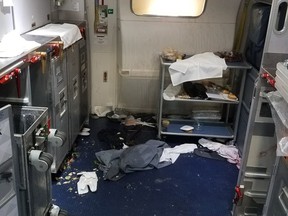 The aftermath of a cabin on Delta Flight 129 from Seattle to Beijing, after authorities say flight attendants struggled with Joseph Daniel Hudek IV, a passenger who lunged for an exit door.