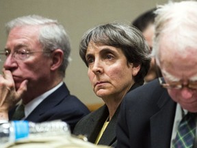 ADVANCE FOR USE SUNDAY, JULY 2 - FILE - In this March 13, 2017, file photo, Liane Shekter Smith, former chief of the Michigan Department of Environmental Quality Office of Drinking Water, listens as a judge in Flint, Mich., denies motions to dismiss charges against five Department of Environmental Quality defendants related to the Flint water crisis. The state's legal bills continue to mount in Flint's man-made water crisis and costs are only expected to balloon as Attorney General Bill Schuette's outside team of investigators turns toward prosecuting a dozen current or former state employees or appointees whose criminal defenses are being covered by taxpayers. (Jake May/The Flint Journal-MLive.com via AP, File)