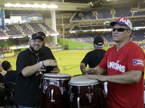 Alberto Reyes, left, and Luisito de Jesus, right, play the bongo drums at Marlins Park before the All-Star Home Run Derby, Monday, July 10, 2017, in Miami. (AP Photo/Lynne Sladky)