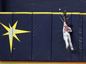 Boston Red Sox center fielder Jackie Bradley Jr. reaches for a home run hit by Tampa Bay Rays' Brad Miller during the eighth inning of a baseball game Sunday, July 9, 2017, in St. Petersburg, Fla. (AP Photo/Mike Carlson)