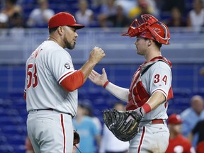 Philadelphia Phillies relief pitcher Joaquin Benoit, left, and catcher Andrew Knapp (34) celebrate after the Phillies defeated the Miami Marlins 10-3 in a baseball game, Wednesday, July 19, 2017, in Miami. (AP Photo/Wilfredo Lee)