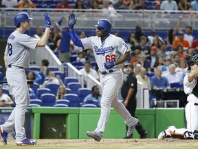 Los Angeles Dodgers' Yasiel Puig (66) is congratulated by Brandon McCarthy after Puig hit a home run during the fifth inning of the team's baseball game against the Miami Marlins, Friday, July 14, 2017, in Miami. (AP Photo/Wilfredo Lee)