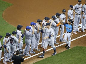 American League's New York Yankees Aaron Judge (99) is greeted by his teammates during the MLB baseball All-Star Game, Tuesday, July 11, 2017, in Miami. (AP Photo/Wilfredo Lee)
