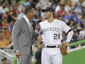 Former player and TV commentator Alex Rodriguez, left, speaks with National League's Colorado Rockies third baseman Nolan Arenado (28), during the first inning at the MLB baseball All-Star Game, Tuesday, July 11, 2017, in Miami. (AP Photo/Lynne Sladky)
