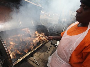 A street food chef cooks jerk chicken at the Notting Hill Carnival on August 29, 2011 in London, England.