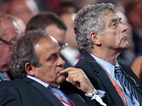 FILE - In this Saturday, July 25, 2015 file photo, UEFA President Michel Platini, left, and FIFA vice president Angel Maria Villar Llona attend the preliminary draw for the 2018 soccer World Cup in Konstantin Palace in St. Petersburg, Russia. UEFA said Thursday, July 27, 2017 vice president Angel Maria Villar, in jail in Spain on suspicion of corruption, has resigned. (AP Photo/Ivan Sekretarev, File)