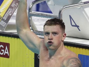 Britain's Adam Peaty celebrates after winning the gold medal in the men's 100-meter breaststroke final during the swimming competitions of the World Aquatics Championships in Budapest, Hungary, Monday, July 24, 2017. (AP Photo/Michael Sohn)