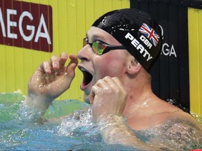 Britain's Adam Peaty celebrates after setting a new world record in a men's 50-meter breaststroke semifinal during the swimming competitions of the World Aquatics Championships in Budapest, Hungary, Tuesday, July 25, 2017. (AP Photo/Michael Sohn)