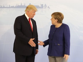 U.S. President Donald Trump, left, and German Chancellor Angela Merkel pose for a photograph prior to a bilateral meeting on the eve of the G-20 summit in Hamburg, northern Germany, Thursday, July 6, 2017. The leaders of the group of 20 meet July 7 and 8. (AP Photo/Matthias Schrader, pool)