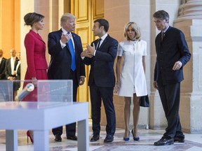 President Donald Trump, first lady Melania Trump, French President Emmanuel Macron his wife Brigitte Macron, tour Marechal Foch's Tomb with David Guillet, director of the Army Museum, at Les Invalides in Paris, Thursday, July 13, 2017.