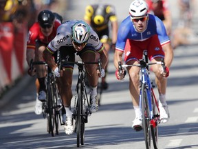 Peter Sagan of Slovakia, center, and France's Arnaud Demare, right, sprint during the fourth stage of the Tour de France cycling race over 207.5 kilometers (129 miles) with start in Mondorf-les-Bains, Luxembourg, and finish in Vittel, France, Tuesday, July 4, 2017. World champion Peter Sagan has been disqualified from the Tour de France for causing a crash in a chaotic sprint finish that left Mark Cavendish needing treatment for his injuries and further examinations in a hospital. (AP Photo/Christophe Ena)