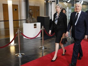 Current British Prime Minister Theresa May and former Prime Minister John Major arrive for a ceremony for former German Chancellor Helmut Kohl at the European Parliament in Strasbourg, eastern France, Saturday July 1, 2017. Current and former leaders from Europe and beyond are gathering in Strasbourg, France to bid farewell to former German Chancellor Helmut Kohl, who died June 16 at 87. (AP Photo/Jean-Francois Badias)