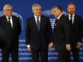 European Commission president Jean-Claude Juncker, left, European Parliament president Antonio Tajani , second left, and European Council President Donald Tusk watch Hungary's Prime Minister Viktor Orban, second right, arriving at a ceremony for former German Chancellor Helmut Kohl at the European Parliament in Strasbourg, eastern France, Saturday July 1, 2017. Current and former world leaders gathered to bid farewell to former German Chancellor Helmut Kohl, recalling a man who was instrumental in uniting Europe and bringing about reconciliation between former adversaries on the continent. (AP Photo/Jean-Francois Badias)