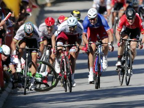 Peter Sagan of Slovakia, left, sprints as Britain's Mark Cavendish crashes during the sprint of the fourth stage of the Tour de France. A number of serious rashes this year have people questioning organizers' changes to the course.