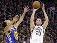 FILE - In this May 6, 2017, file photo, Utah Jazz forward Gordon Hayward (20) shoots as Golden State Warriors guard Shaun Livingston (34) defends in the second half during Game 3 of the NBA basketball second-round playoff series in Salt Lake City. Hayward has chosen to sign with the Boston Celtics and reunite with coach Brad Stevens, making the announcement Tuesday evening, July 4, on The Players' Tribune site. (AP Photo/Rick Bowmer, File)