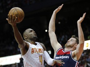 In this April 28, 2017, photo, Atlanta Hawks forward Paul Millsap (4) shoots against Washington Wizards forward Jason Smith (14) in the first half of an NBA playoff basketball game in Atlanta. A person with knowledge of the situation told The Associated Press on Sunday, July 2, that Paul Millsap has agreed to terms with the Denver Nuggets on a three-year deal worth $90 million. The person spoke on condition of anonymity because the contract cannot be signed until Thursday. (AP Photo/John Bazemore)