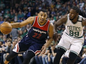 FILE - In this April 30, 2017, file photo, Washington Wizards' Otto Porter Jr. (22) drives past Boston Celtics' Jae Crowder (99) during the third quarter of a second-round NBA playoff series basketball game, in Boston. Following his best NBA season, Otto Porter Jr. has a big offer to join the Brooklyn Nets. Porter has agreed to sign an offer sheet with the Nets, a person with knowledge of the details said. The Wizards plan to match the offer and keep Porter, the person told The Associated Press on Wednesday, July 5, 2017. The person spoke on condition of anonymity because contracts can't be signed until Thursday. (AP Photo/Michael Dwyer, File)