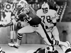 FILE - In this Sept. 3, 1977 file photo, Buffalo Bills' O.J. Simpson (32) runs past Tampa Bay Buccaneers' Council Rudolph (78) during an NFL football game in Buffalo, N.Y. Simpson, the former football star, TV pitchman and now Nevada prison inmate, will have a lot going for him when he appears before state parole board members Thursday, July 20, 2017, seeking his release after more than eight years for an ill-fated bid to retrieve sports memorabilia. (AP Photo, file)