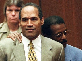 FILE - In this Oct. 3, 1995 file photo, attorney Johnnie Cochran Jr., right, holds onto O.J. Simpson as the not guilty verdict is read in a Los Angeles courtroom. Simpson, the former football star, TV pitchman and now Nevada prison inmate, will have a lot going for him when he appears before state parole board members Thursday, July 20, 2017, seeking his release after more than eight years for an ill-fated bid to retrieve sports memorabilia. (AP Photo/Pool, Myung J. Chun, file)