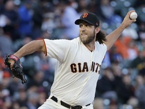 San Francisco Giants pitcher Madison Bumgarner throws against the Pittsburgh Pirates during the first inning of a baseball game in San Francisco, Tuesday, July 25, 2017. (AP Photo/Jeff Chiu)