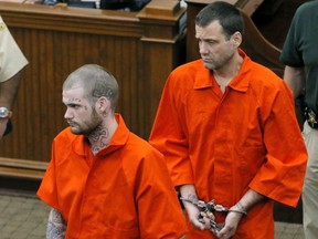 FILE - In this June 21, 2017, file photo, Ricky Dubose, left, and Donnie Russell Rowe enter the Putnam County courthouse  in Eatonton, Ga. Georgia corrections officials are reporting there were numerous security policy violations in the lead-up to the escape of the two inmates from a prison bus last month. (Bob Andres/Atlanta Journal-Constitution via AP, Pool, File)