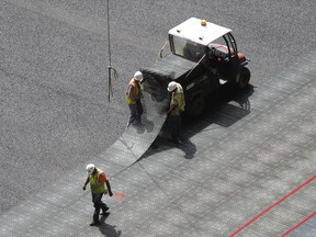Workers install flooring at Mercedes Benz Stadium, the new home of the Atlanta Falcons football team and the Atlanta United soccer team, in Atlanta. (AP Photo/John Bazemore)