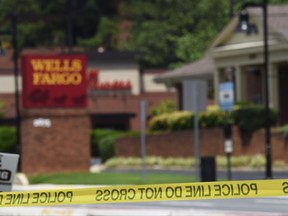 Police tape blocks the entrance to a Wells Fargo Bank in Marietta, Ga., Friday, July 7, 2017, following reports of man claiming to have a bomb with possible hostages inside. (AP Photo/Mike Stewart)