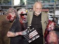 Director George Romero poses with some fans dressed as zombies after accepting a special award during the Toronto International Film Festival in 2009.
