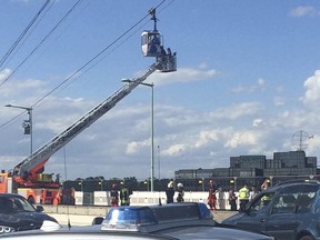 Firefighters rescue people out of a cable car gondola in Cologne. Germany Sunday, July 30, 2017.