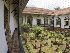 This Friday June 2, 2017 photo shows the back garden of the 427-year-old Figueiredo Mansion, a Portuguese heritage home, in Goa, India. The Figueiredo family of Portuguese diplomats, lawyers and parliamentarians began building the mansion in 1590 as they made their home in Loutolim, a quaint village surrounded by paddy fields about an hour's drive from Goa's airport. Today, three generations of the Figueiredo family live in the house, providing visitors and guests with a personal, living link to history. (AP Photo/Manish Mehta)