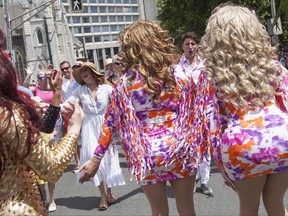 Sophie Gregoire Trudeau and her husband, Canadian Prime Minister Justin Trudeau, react to a pair of drag queens, while taking part in the annual Halifax Pride Parade on Saturday, July 22, 2017. THE CANADIAN PRESS/Stringer