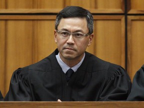 FILE - This Dec. 2015 file photo shows U.S. District Judge Derrick Watson in Honolulu. Watson on Thursday, July 13, 2017, expanded the list of family relationships needed by people seeking new visas from six mostly Muslim countries to avoid President Donald Trump's travel ban. Watson ordered the government not to enforce the ban on grandparents, grandchildren, brothers-in-law, sisters-in-law, aunts, uncles, nieces, nephews and cousins of people in the United States. (George Lee /The Star-Advertiser via AP, File)