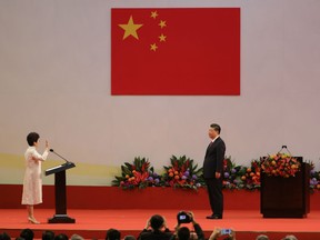 Carrie Lam, Hong Kong's incoming chief executive cites the oath of office as Xi Jinping, China's president, looks on