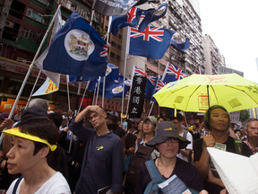 Pro-independence and  pro-democracy activists hold Hong Kong's old colonial flag during a protest in Hong Kong, July 1, 2017.