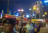 Police stand guard as decorations celebrate the 20th anniversary of the Hong Kong’s handover in the Wan Chai district of Hong Kong.