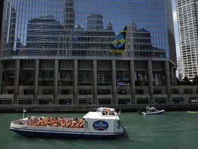A giant banner from Greenpeace hangs on the side of Trump Tower in Chicago on Friday, July 7, 2017. Greenpeace activists unfurled the banner to protest the Trump administration's stance on global warming. (Jose M. Osorio/Chicago Tribune via AP)