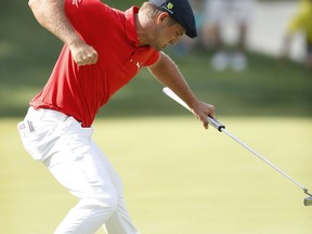 Bryson DeChambeau reacts after making a birdie putt on the 18th green during the final round of the John Deere Classic golf tournament, Sunday, July 16, 2017, at TPC Deere Run in Silvis, Ill. (AP Photo/Charlie Neibergall)