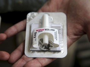 In this June 14, 2017, photo, Cook County Sheriff Tom Dart shows Naloxone, an overdose-reveal nasal spray drug at the sheriff's office in Cook County Jail, the largest single site jail in the United States, has joined the growing number of jails to hand to inmates on their way out the door kits containing naloxone. (AP Photo/G-Jun Yam)