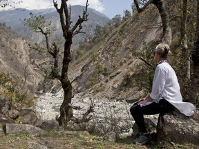 In this March 26, 2017 photo, Elizabeth Brenner rests on a rock on the Milam Glacier Trail near the town of Munsiyari, in the mountains of north India. Brenner was on a "pilgrimage" following the last footsteps of her son, Thomas Plotkin, who slipped and fell more than 300 feet down a steep gorge while on a study abroad trip to the mountains of India in September 2011. His body was never found. Hundreds of thousands of American students study abroad each year, but no one can say exactly how many are injured or die.(AP Photo/Rishabh R. Jain)