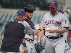 Cleveland Indians manager Terry Francona, left, takes the ball to relieve relief pitcher Boone Logan, right, as catcher Yan Gomes, center, looks on in the ninth inning of a baseball game against the Detroit Tigers in Detroit, Sunday, July 2, 2017. Cleveland won 11- 8. (AP Photo/Rick Osentoski)