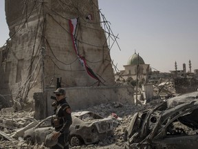 An Iraqi Special Forces soldier walks in the destroyed al-Nuri mosque complex as Iraqi forces continue their advance against Islamic State militants in the Old City of Mosul, Iraq, Sunday, July 2, 2017. (AP Photo/Felipe Dana)